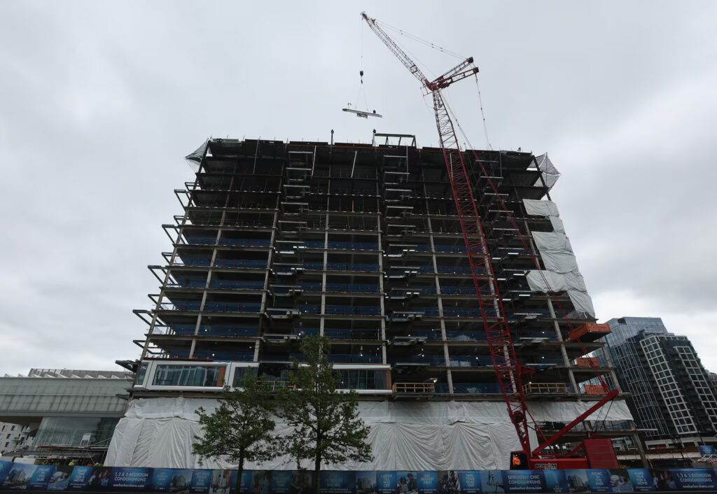 Final piece of Fan Pier put in place with luxury condo tower topping-off