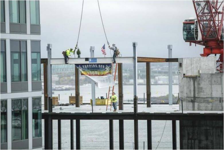 Iron workers top off luxury condo tower at Fan Pier
